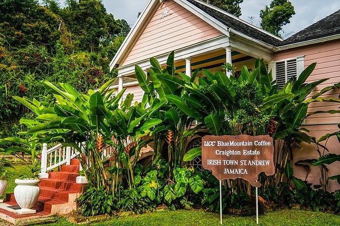 The pink great house at Craighton Estate behind its sign at Irish Town, St Andrew